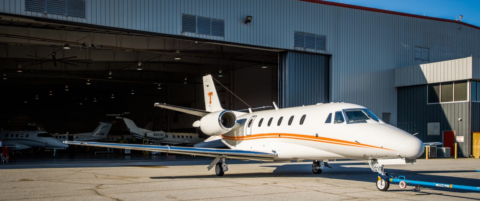 Private jet being towed from a hangar